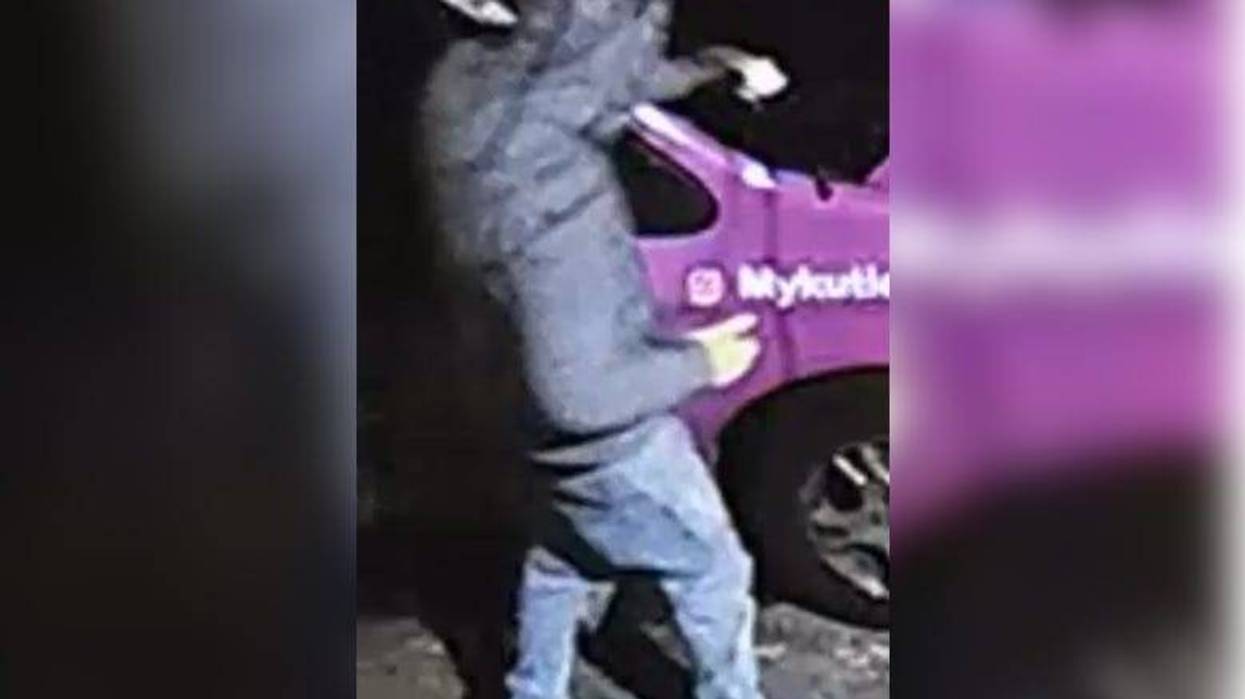 Surveillance video shows a man pouring what appears to be a flammable substance on the windshield of an SUV