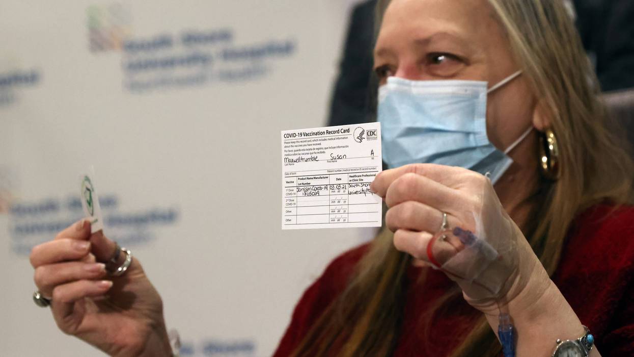Susan Maxwell-Trumble holds up a vaccination card at South Shore University Hospital after receiving the Johnson & Johnson COVID-19 vaccine on March 03, 2021 in Bay Shore, New York.