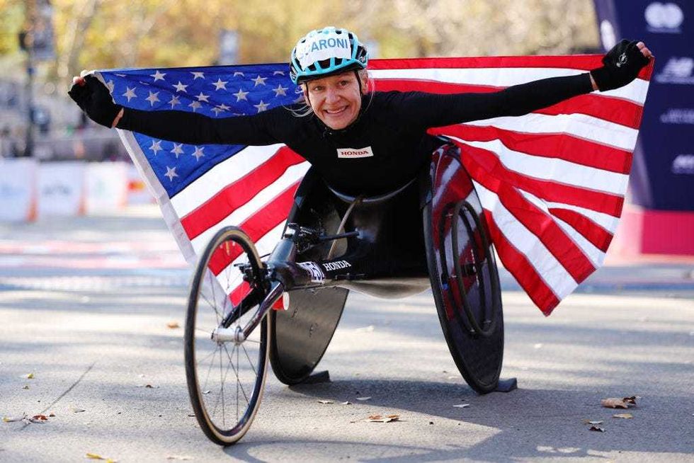 Susannah Scaroni of the United States poses with the flag after winning the Professional Women