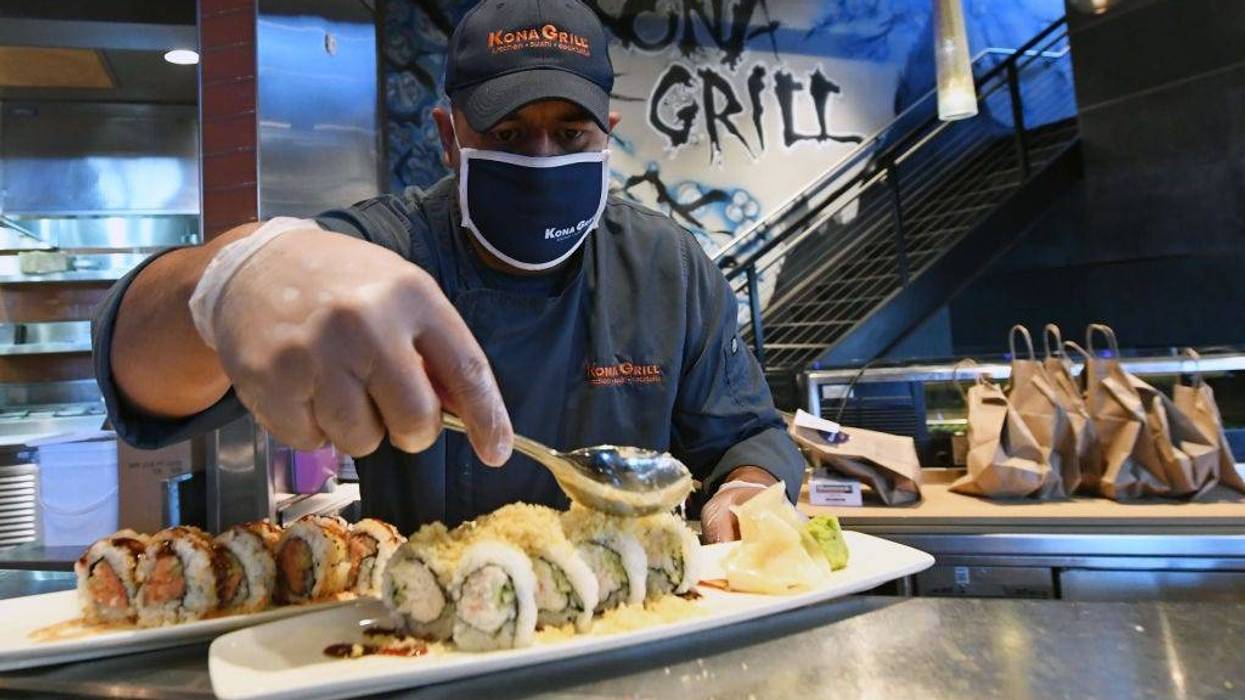 Sushi chef Juan Hernandez prepares food at Kona Grill in Boca Park Fashion Village as some businesses that were closed seven weeks ago to fight the spread of the coronavirus are allowed to reopen on May 9, 2020 in Las Vegas, Nevada.