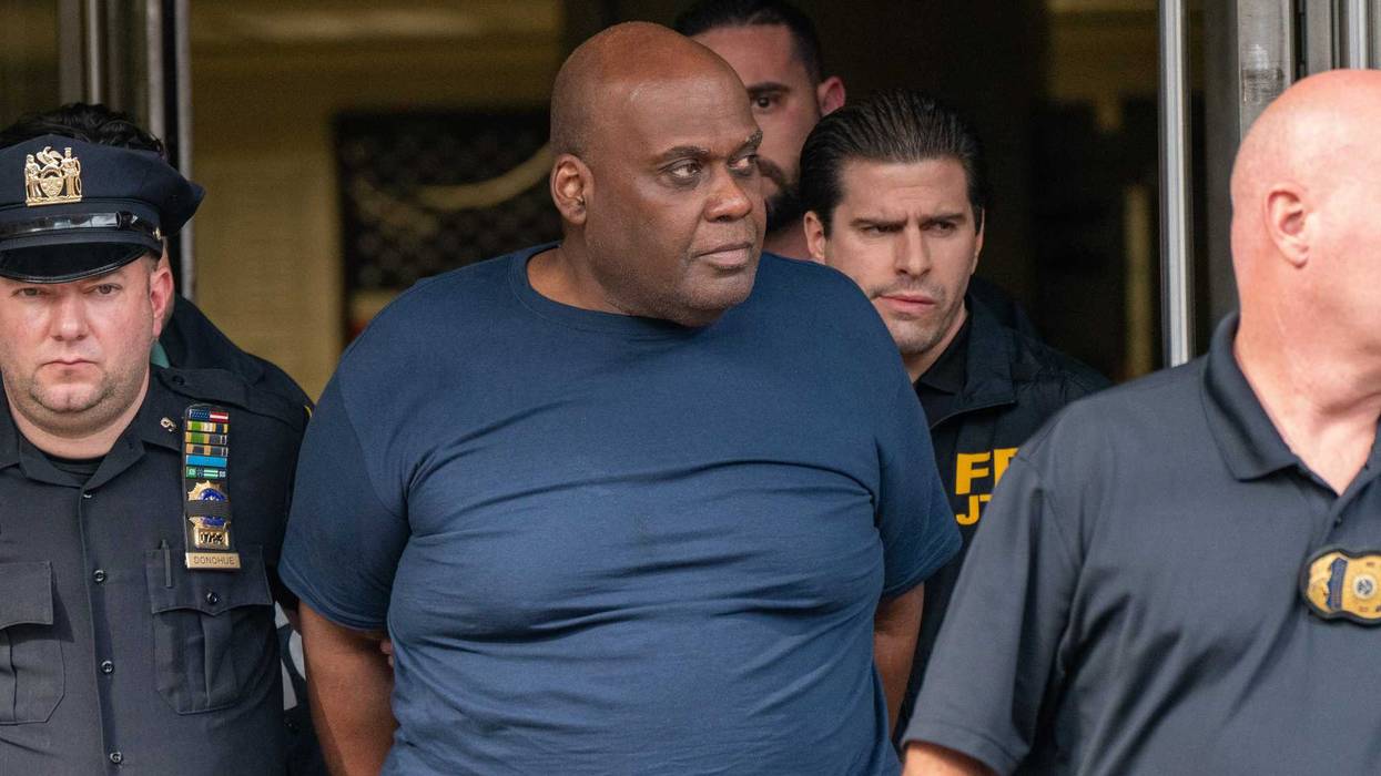 Suspect Frank James is escorted out of the 9th Precinct by police on April 13, 2022