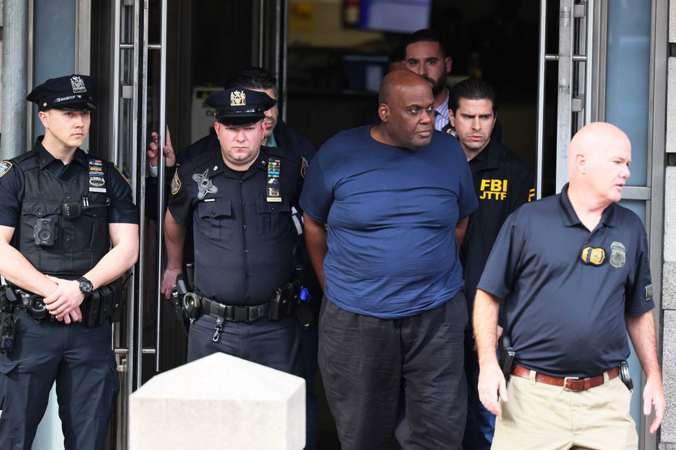 Suspect Frank James is led by police from the Ninth Precinct stationhouse in Manhattan on April 13, 2022 after being arrested in the mass shooting at the 36th Street subway station in Sunset Park