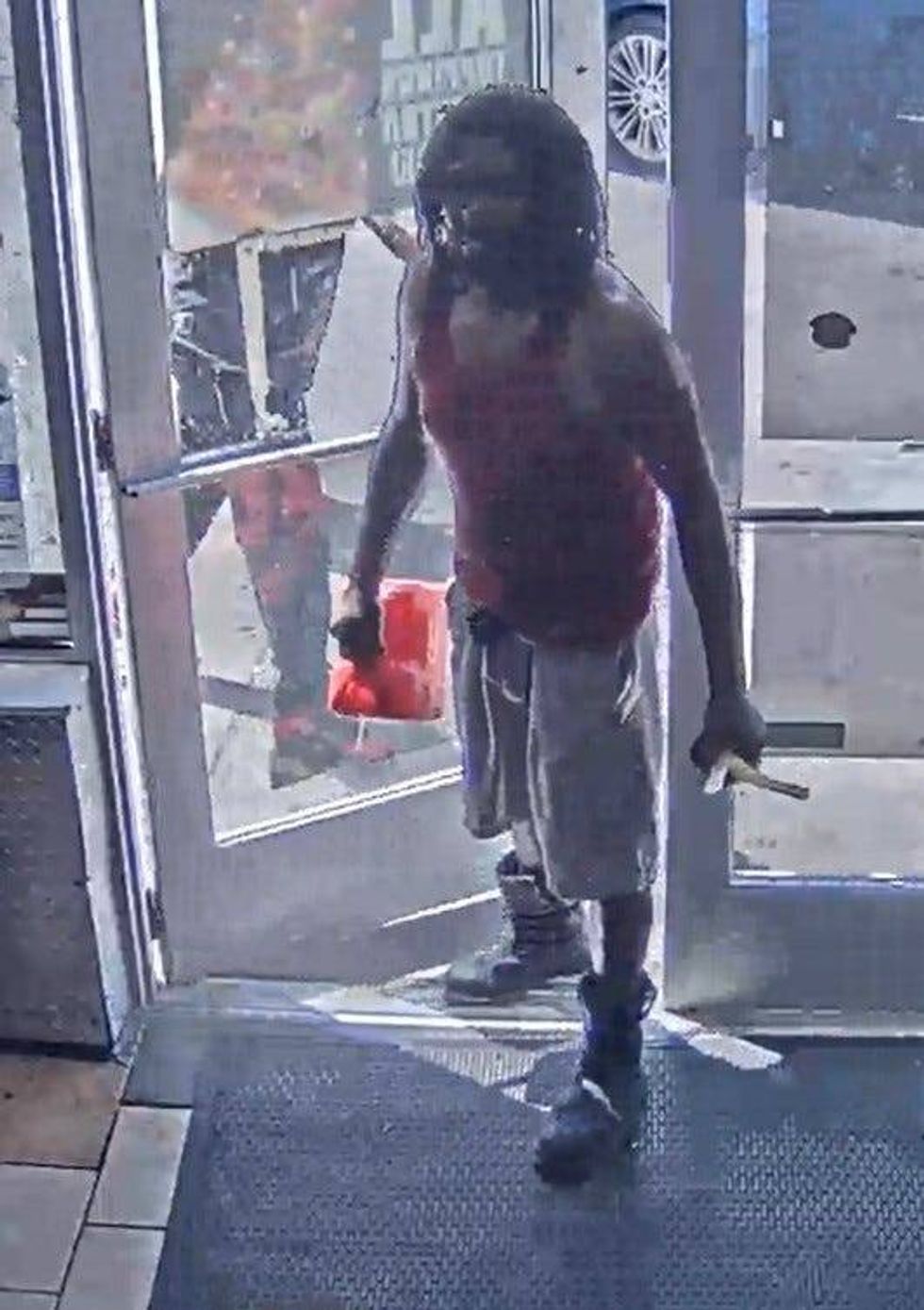 Suspect holding gas can and torch