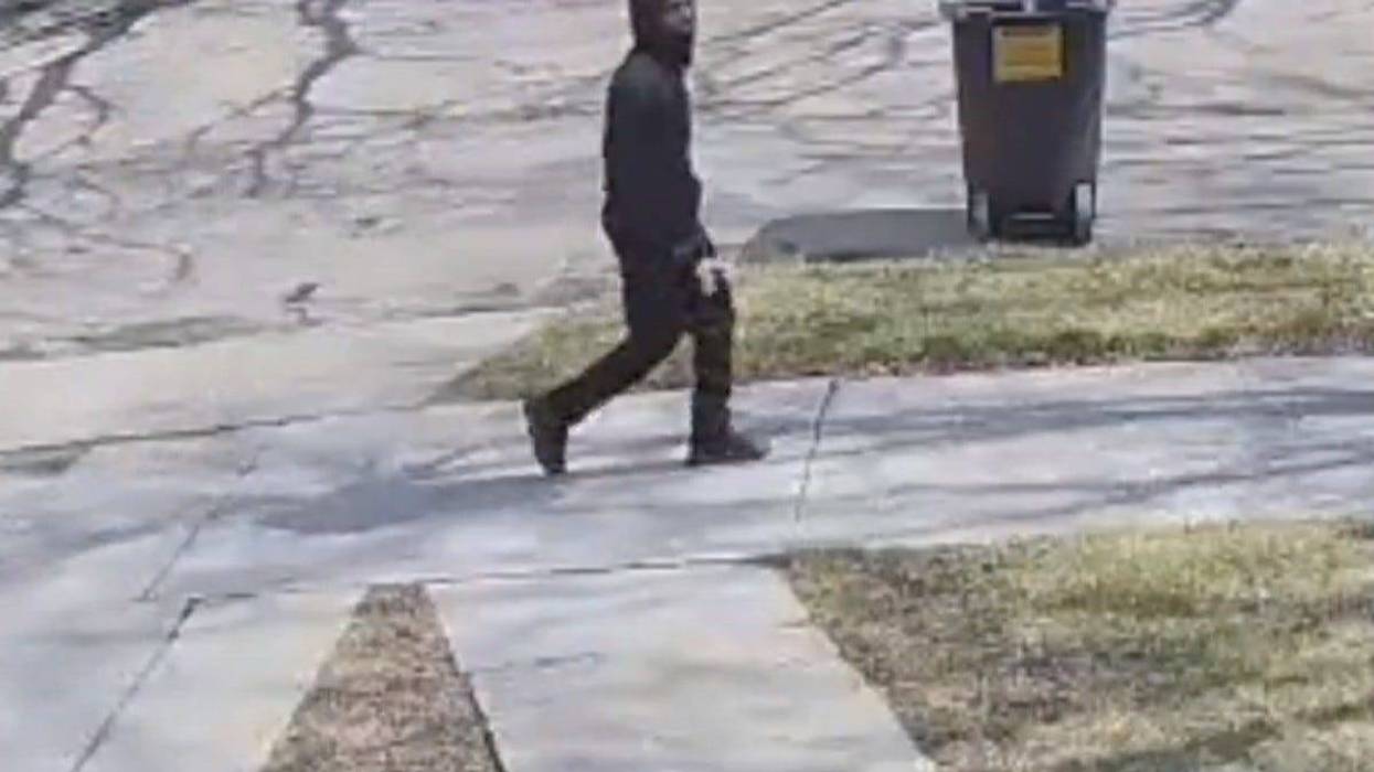 Suspect in sexual assault walking on the sidewalk