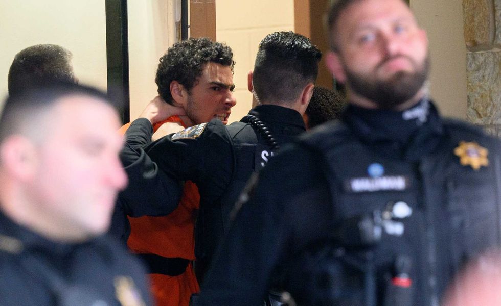 Suspected shooter Luigi Mangione is led into the Blair County Courthouse for an extradition hearing December 10, 2024