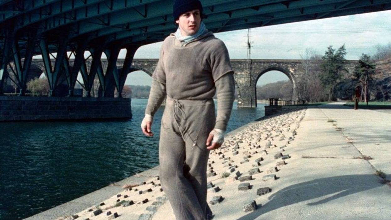 Sylvester Stallone as Rocky Balboa standing by the Schuylkill River in Fairmount Park.
