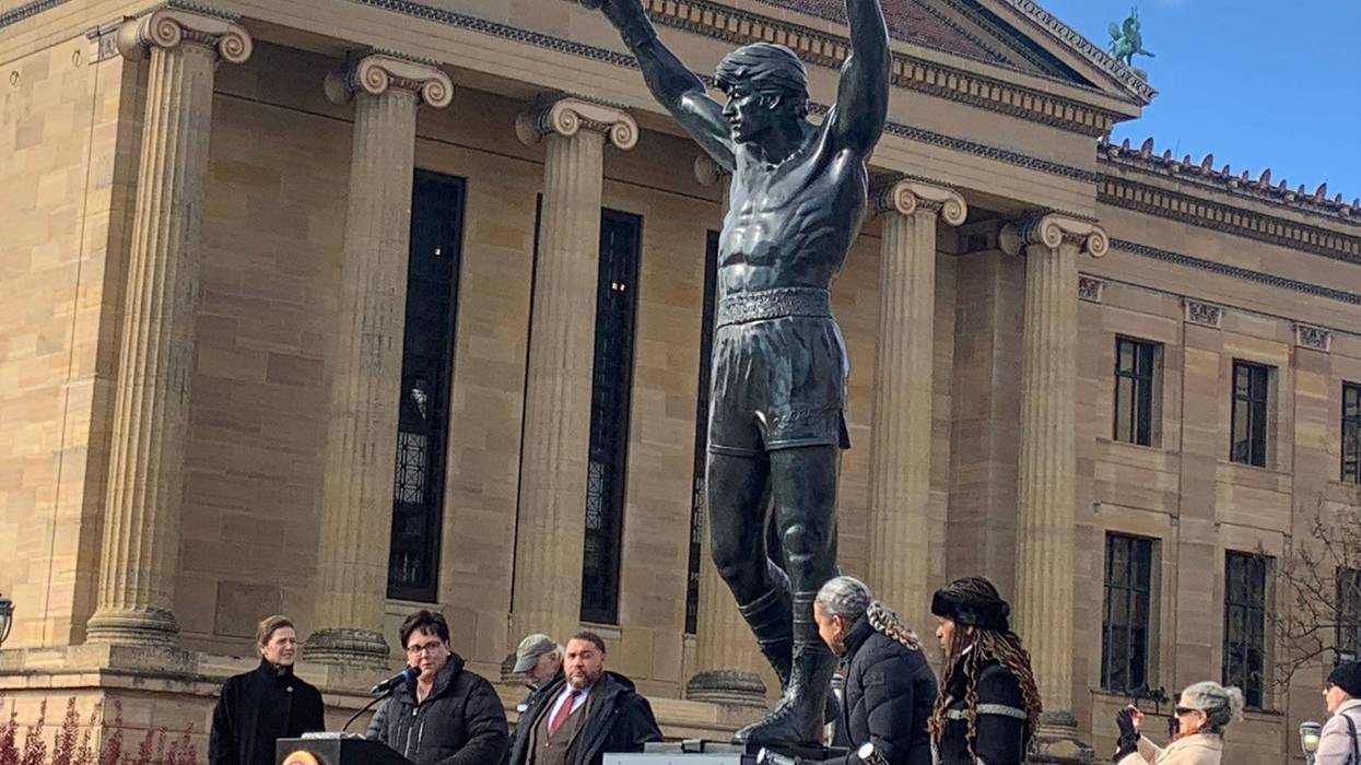 Sylvester Stallone's personal "Rocky" statue stands at the top of the Philadelphia Museum of Art steps at the kickoff event for RockyFest, surrounded by city officials.