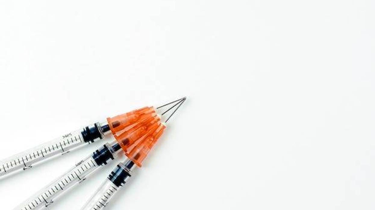 Syringes with needles on white background