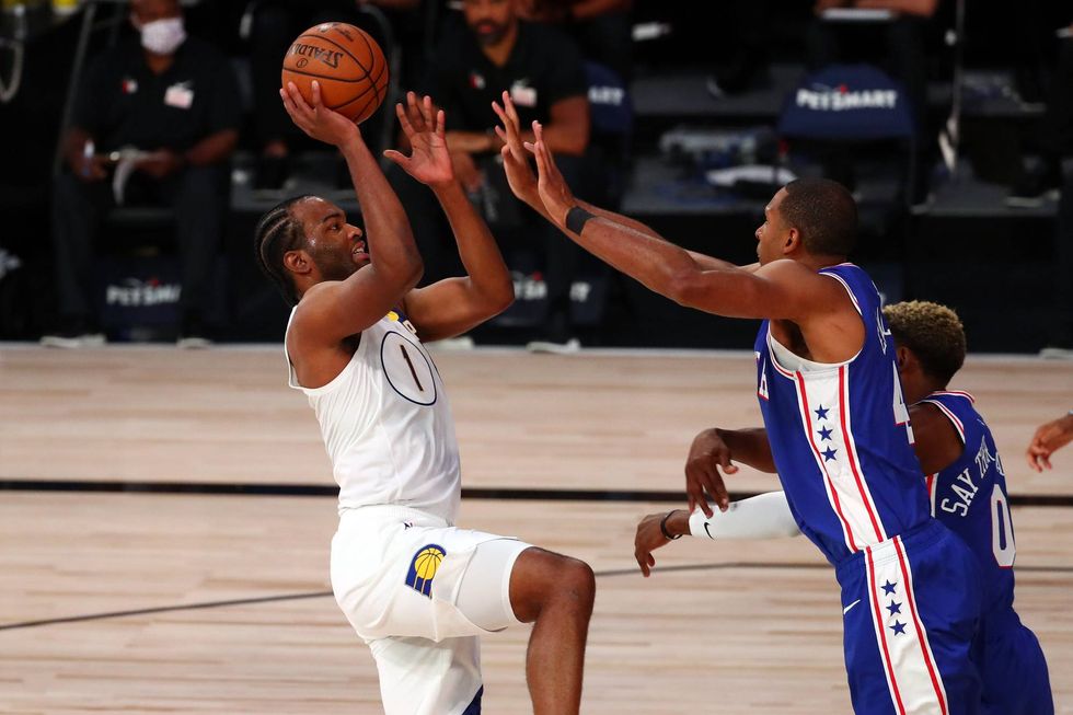 T.J. Warren skies over Sixers defender Al Horford