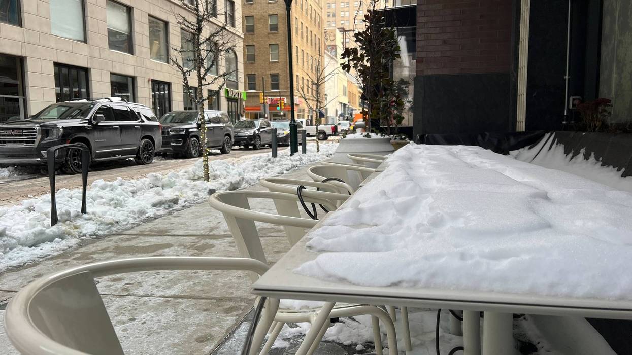 table and chairs covered in snow in Center City
