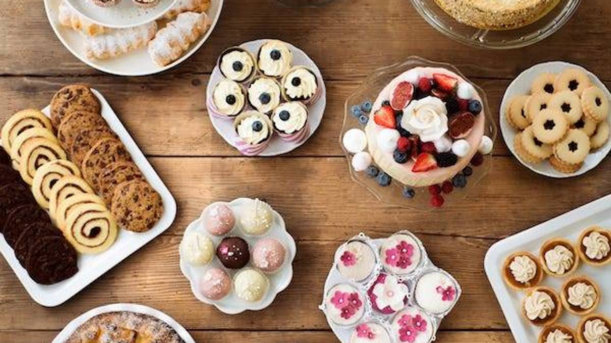 Table with cakes, cookies, cupcakes, tarts and cakepops