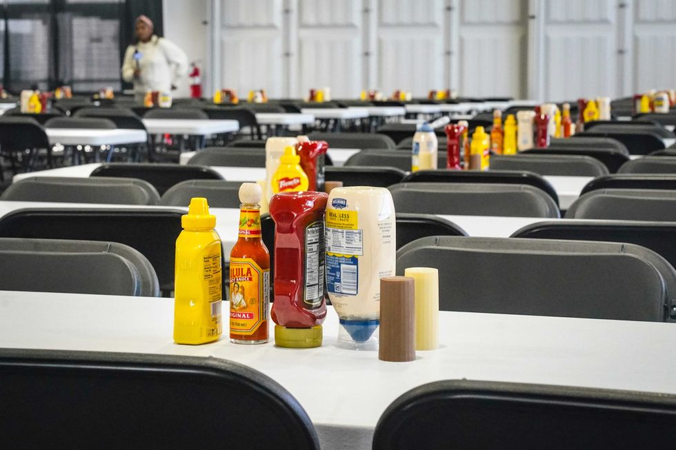 Tables set with condiments for scores of individuals, shown during a media tour, is part of New York City