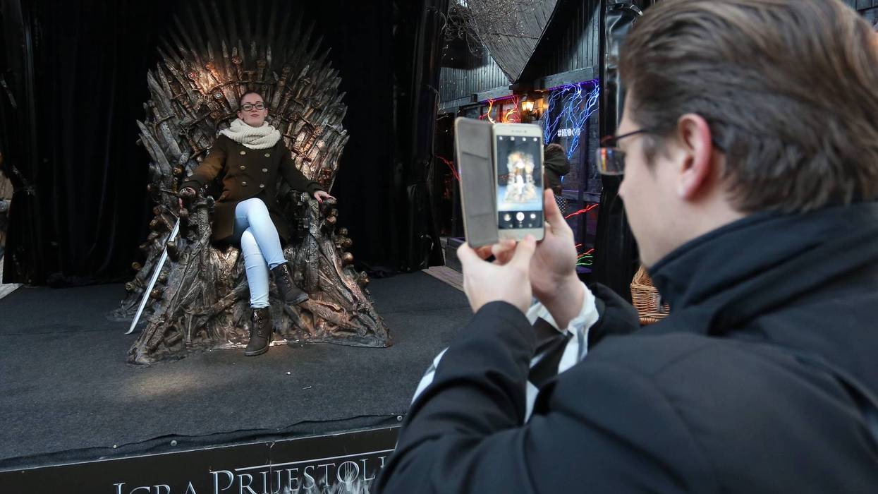 Taking a photo with the iron throne