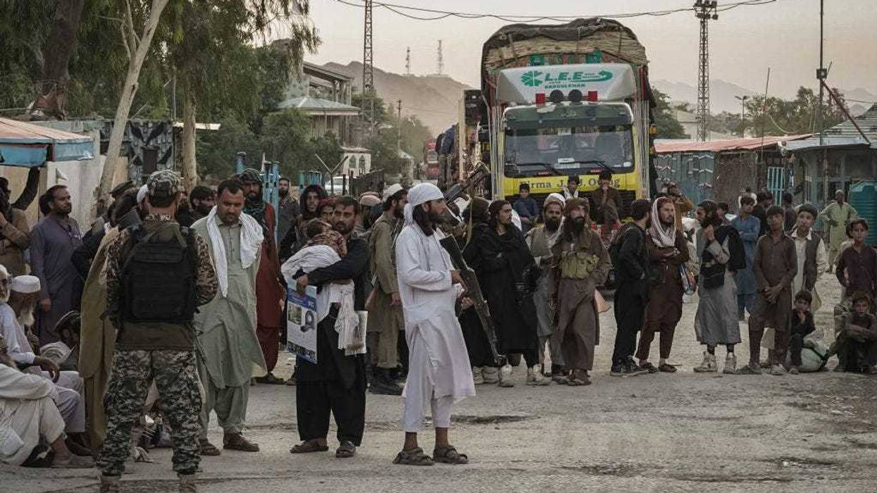 Taliban fighters guard the Afghanistan side of the Torkham crossing on August 20, 2021 as seen from Torkham, Pakistan. (Photo by Danial Shah/Getty Images)