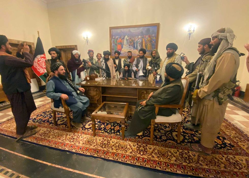 Taliban fighters take control of the Afghan presidential palace after the Afghan President Ashraf Ghani fled the country, in Kabul, Afghanistan, Sunday, Aug. 15, 2021.