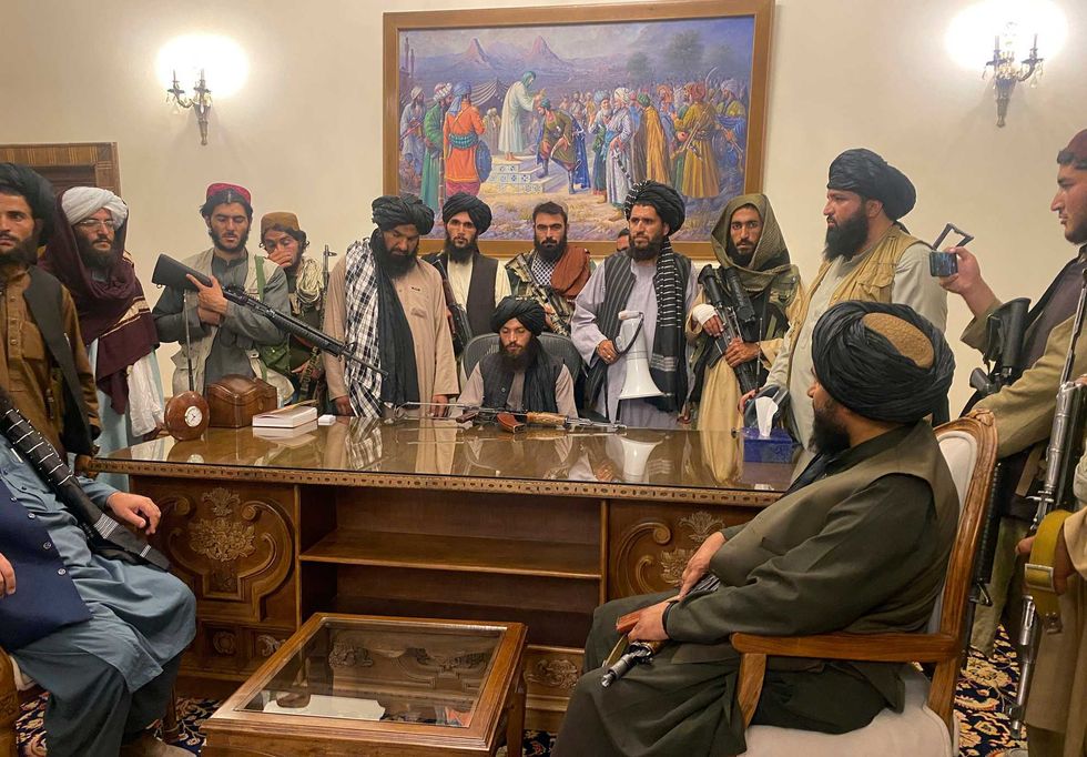 Taliban fighters take control of the Afghan presidential palace after the Afghan President Ashraf Ghani fled the country, in Kabul, Afghanistan, Sunday, Aug. 15, 2021.