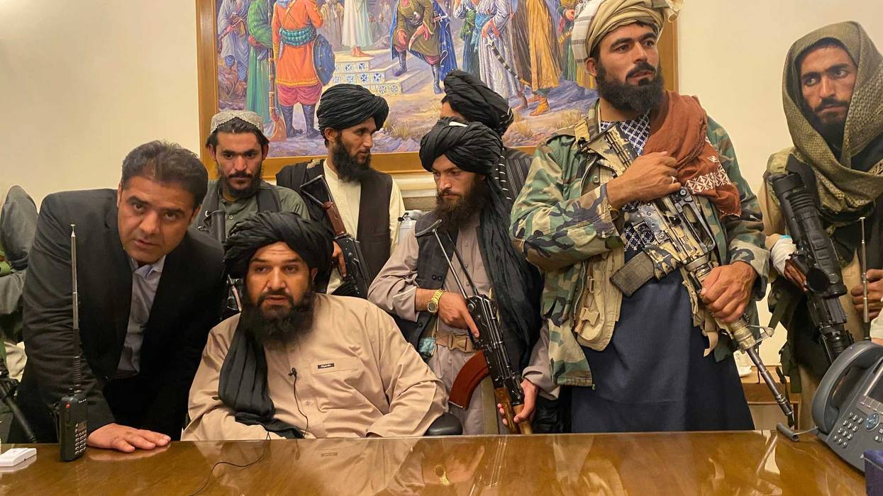 Taliban fighters take control of the Afghan presidential palace after the Afghan President Ashraf Ghani fled the country, in Kabul, Afghanistan, Sunday, Aug. 15, 2021.
