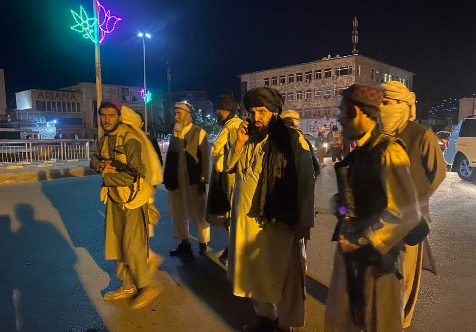 Taliban fighters take control of the Afghan presidential palace after the Afghan President Ashraf Ghani fled the country, in Kabul, Afghanistan, Sunday, Aug. 15, 2021.
