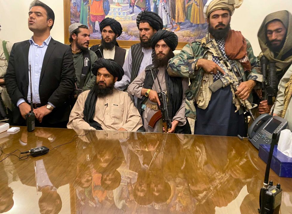 Taliban fighters take control of the Afghan presidential palace after the Afghan President Ashraf Ghani fled the country, in Kabul, Afghanistan, Sunday, Aug. 15, 2021.