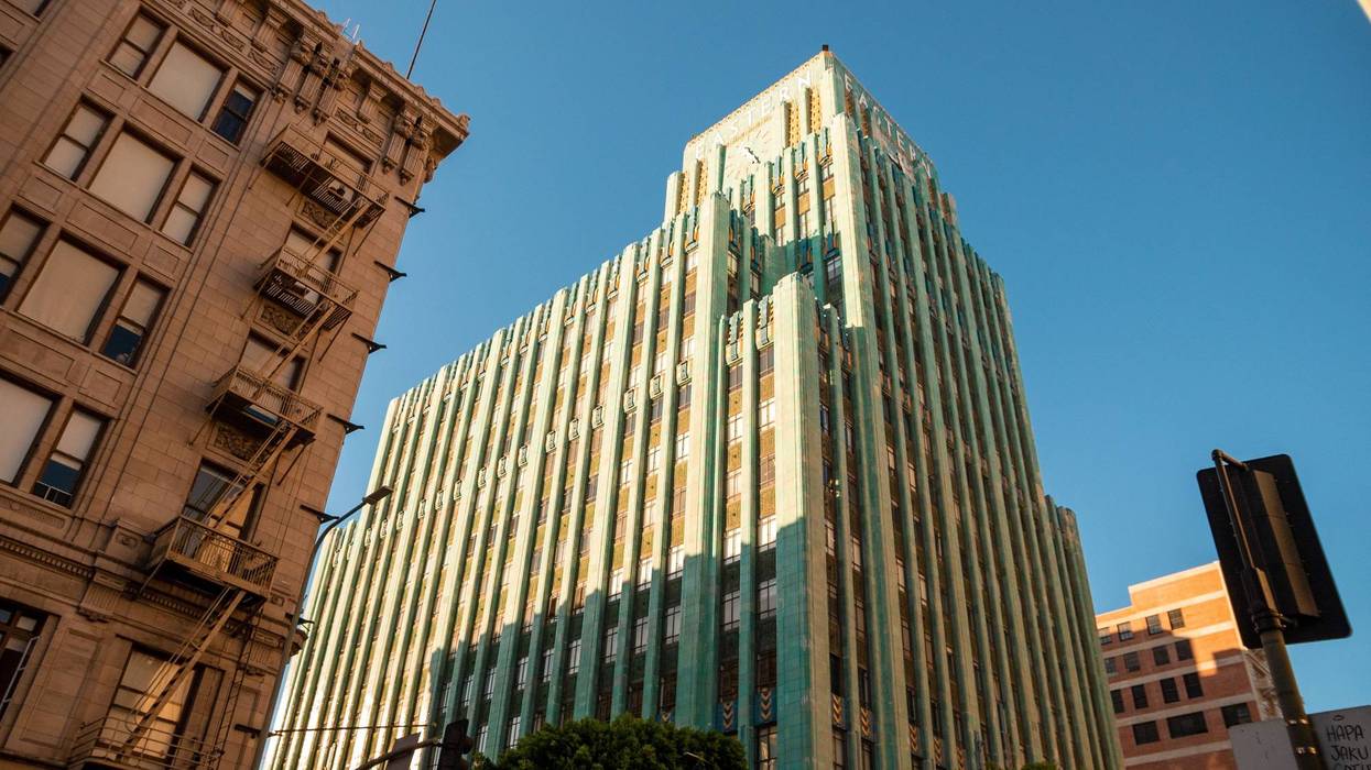 tall turquoise art deco building in downtown los angeles