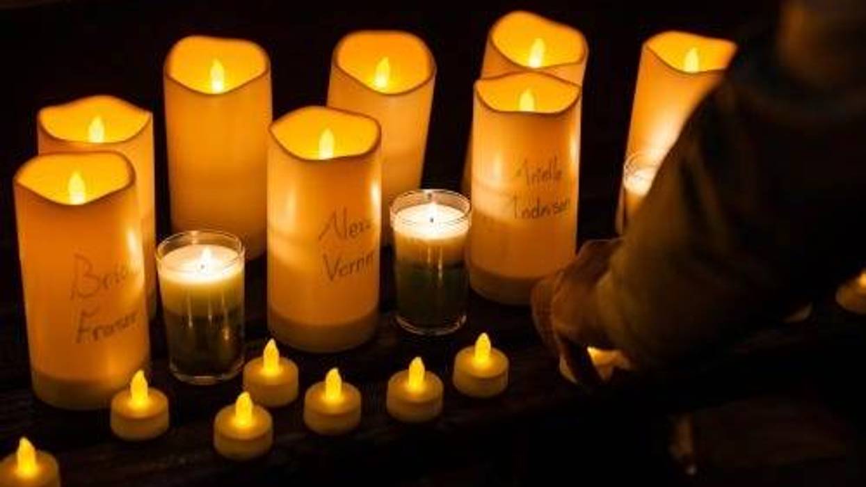Talyce Murray, who graduated from Michigan State University in 2020, prepares candles for a vigil at DuPont Circle in Washington, D.C. on February 16, 2023, to honor victims of the shooting on the campus of Michigan State University. Three people were killed and 5 wounded by a lone gunman.
