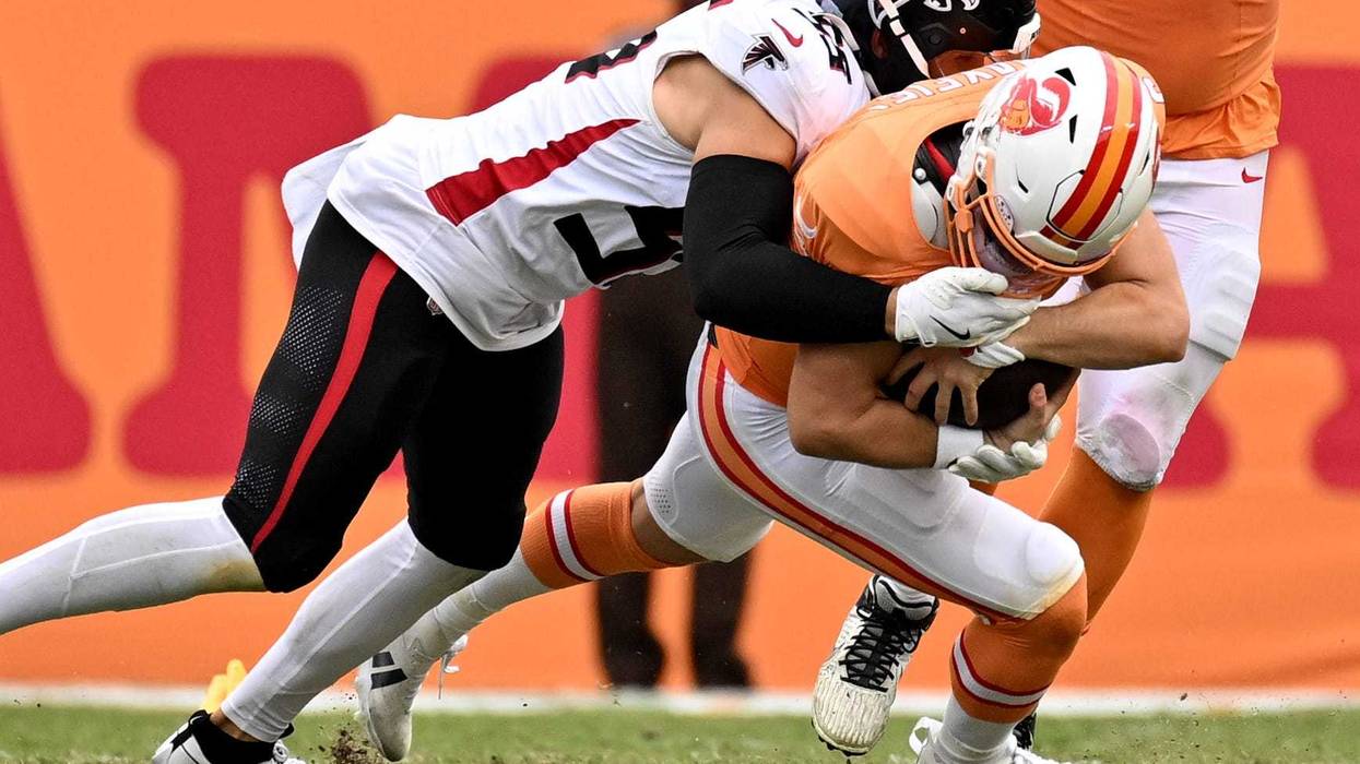 Tampa Bay Buccaneers quarterback Baker Mayfield (6) gets tackled by Atlanta Falcons linebacker Kaden Elliss (55) in the second half at Raymond James Stadium.