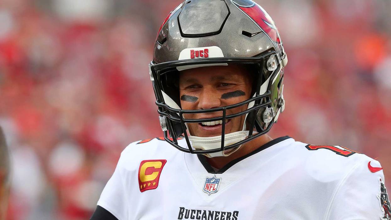 Tampa Bay Buccaneers Quarterback Tom Brady (12) smiles as he talks with a team mate before the regular season game between the Carolina Panthers and the Tampa Bay Buccaneers on January 9, 2022 at Raymond James Stadium in Tampa, Florida.