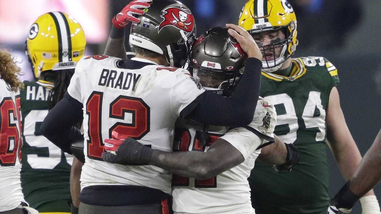 Tampa Bay Buccaneers quarterback Tom Brady celebrates with running back Ronald Jones after defeating the Green Bay Packers during the NFC championship game Sunday, January 24, 2021, at Lambeau Field