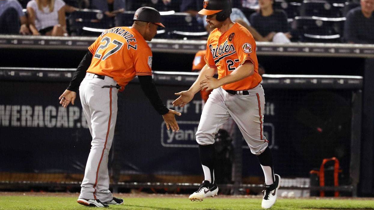 Tampa, FL, USA; Baltimore Orioles major catcher Andrew Susac (27) is congratulated by major league coach Jose Hernandez (27) as he hits a home run during the third inning against the New York Yankees at George M. Steinbrenner Field