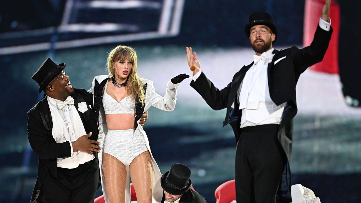 Taylor Swift is joined on stage by Travis Kelce (R), during "Taylor Swift | The Eras Tour" at Wembley Stadium on June 23, 2024 in London, England.