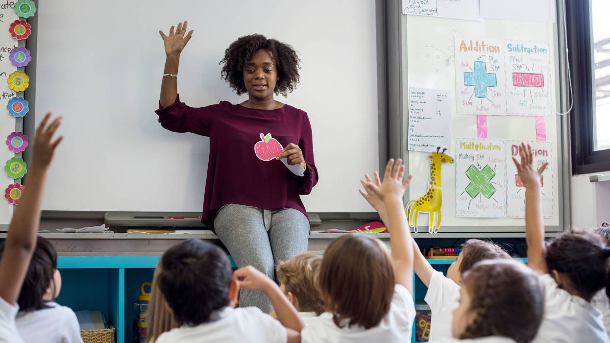 Teacher teaching in classroom stock photo