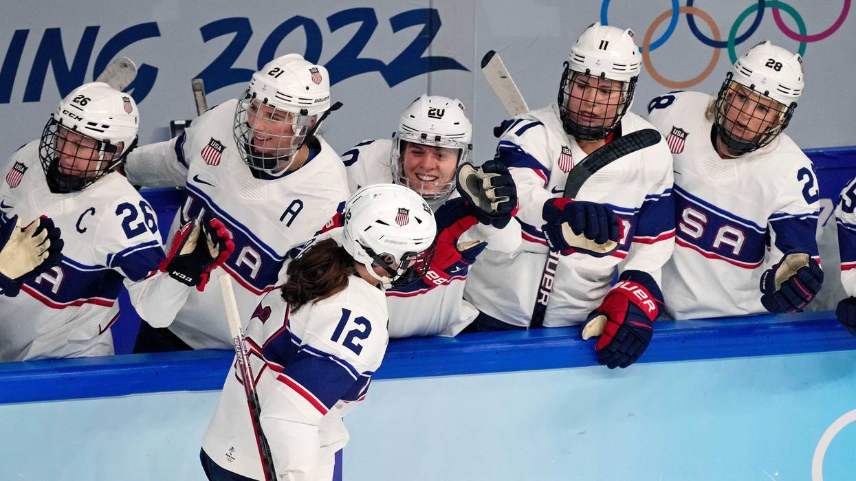 Team United States forward Kelly Pannek (12) is congratulated by the bench after scoring a goal against Switzerland during the first period during the Beijing 2022 Olympic Winter Games at Wukesong Sports Centre.