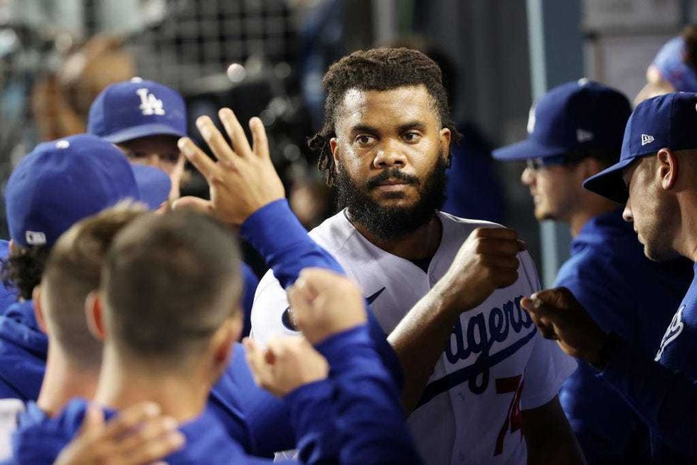 Teammates greet Kenley Jansen #74 of the Los Angeles Dodgers in the dugout after the top of the ninth inning against the St. Louis Cardinals.