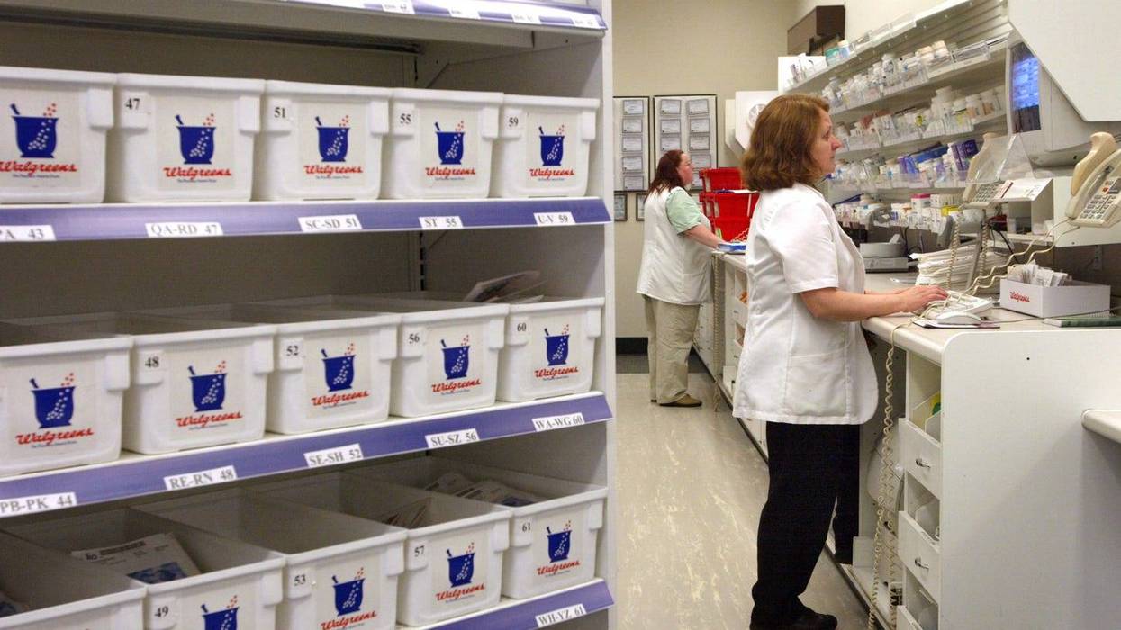 Technicians work inside a Walgreens pharmacy