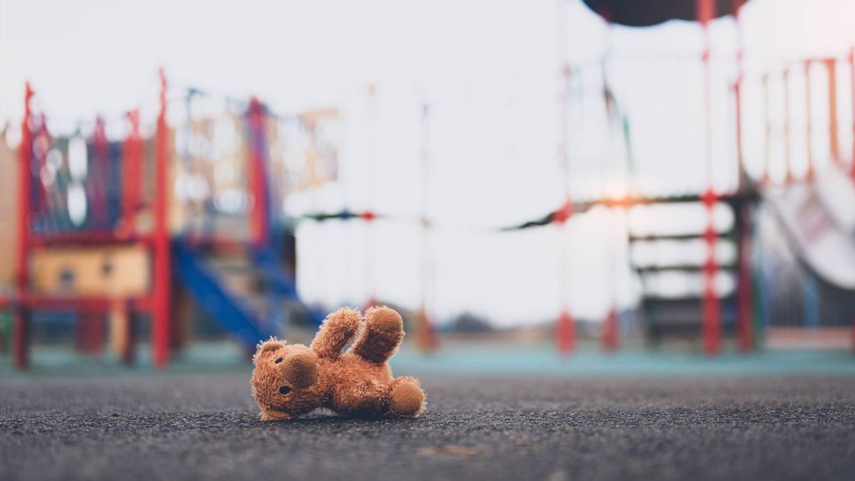 Teddy bear on ground by play structure