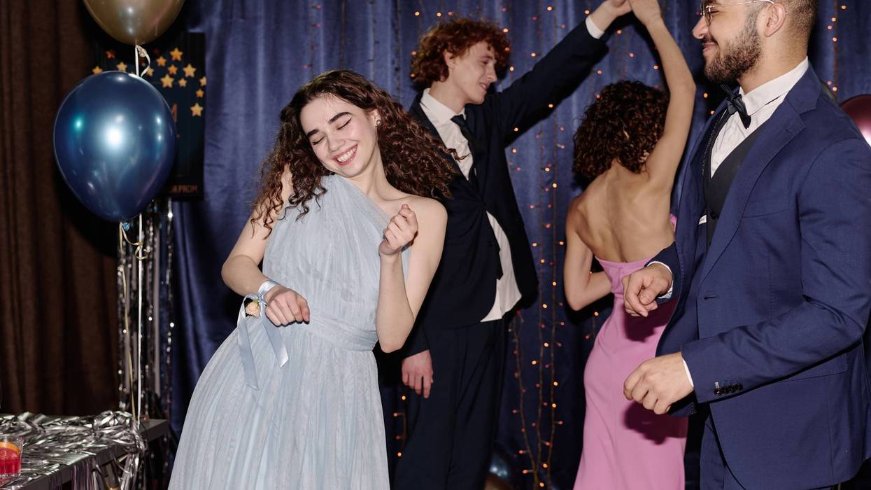 Teen Dancing Joyfully with Friends at Formal Party Event