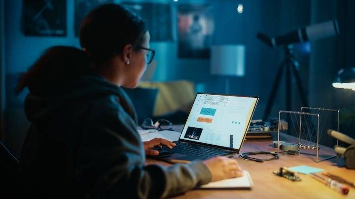 Teen girl wearing glasses working on a computer
