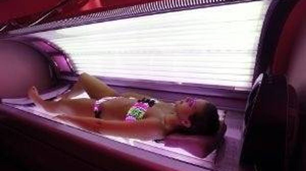 Teen in a tanning booth
