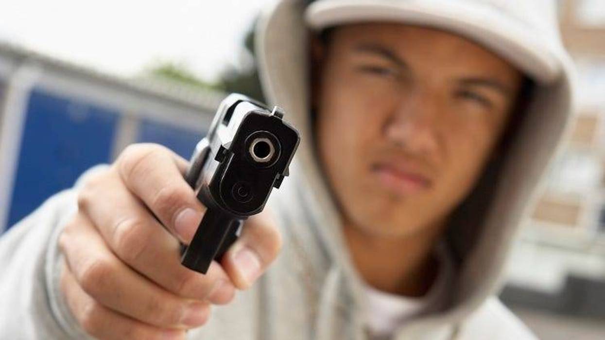 Teenage boy with gun