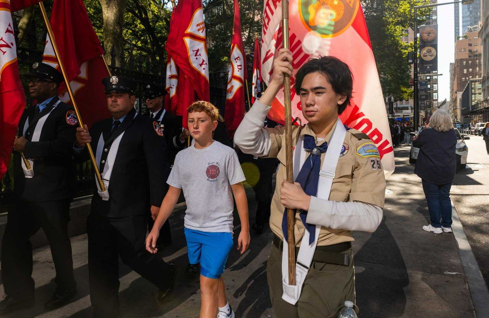 Teens join a procession of New York City firefighters near the National September 11 Memorial & Museum in lower Manhattan on the 24th anniversary of the 9/11 terror attacks on September 11, 2025