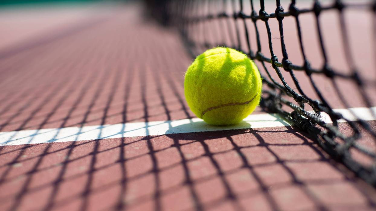 Tennis ball lying on the court