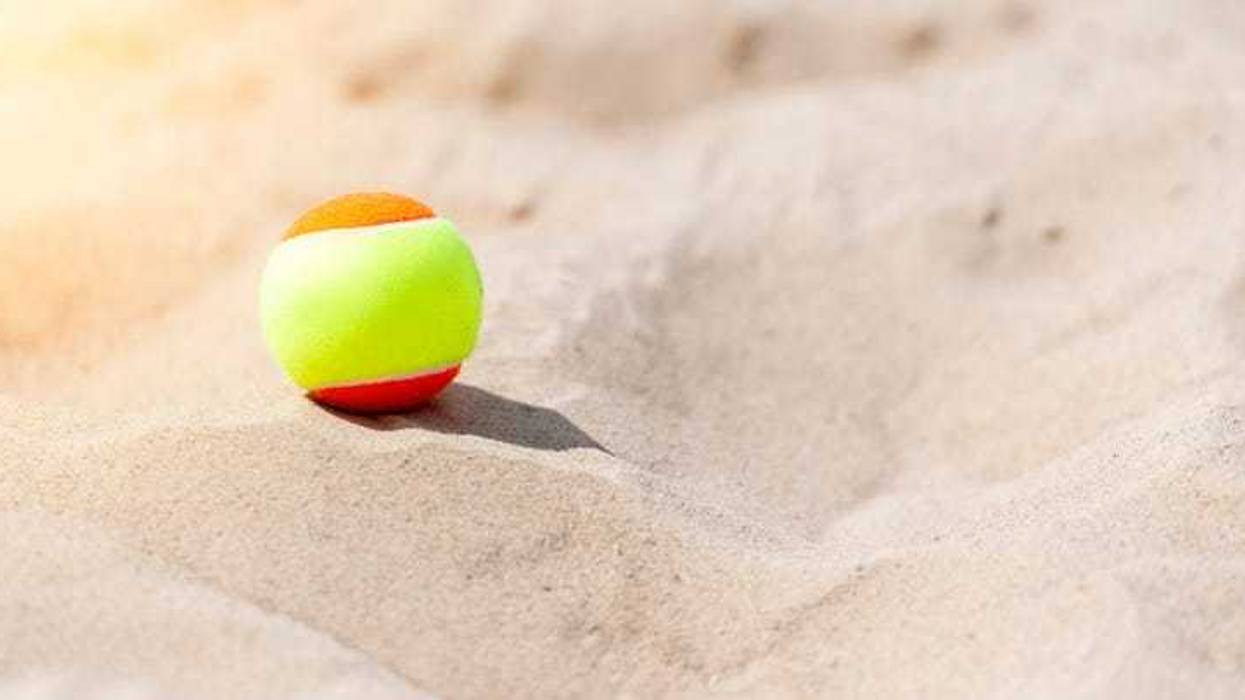 Tennis ball on the beach.
