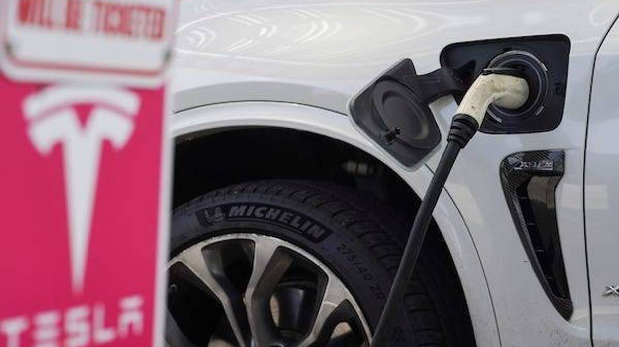 Tesla being charged at power station