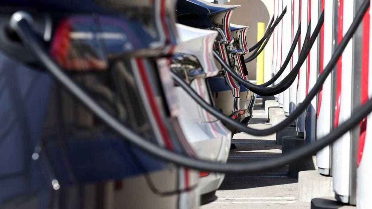 Tesla electric cars recharge at a Tesla Supercharger station on January 16, 2024 in Burbank, California.