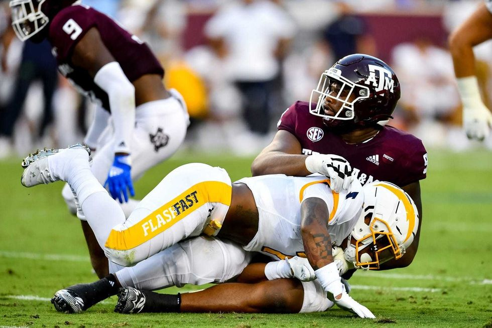 Texas A&M Aggies defensive lineman Jayden Peevy (92) tackles Kent State Golden Flashes running back Marquez Cooper (1) during the first half at Kyle Field