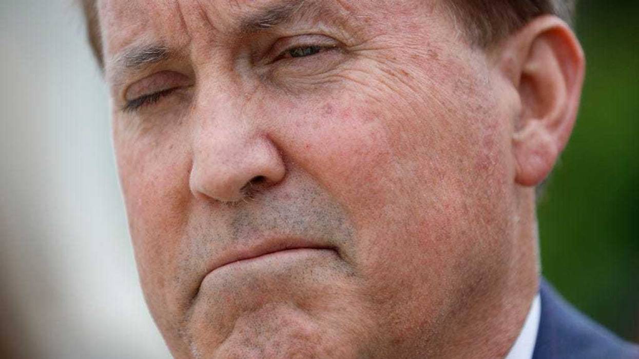 Texas Attorney General Ken Paxton talks to reporters after the U.S. Supreme Court heard arguments in a case Texas brought against the Biden Administration about Title 42 on April 26, 2022 in Washington, DC. Paxton and Schmitt, who is running for the U.S. Senate in Missouri, are suing to challenge the the Biden Administration's repeal of the Trump Migrant Protection Protocols—aka “Remain in Mexico.” (Photo by Chip Somodevilla/Getty Images)