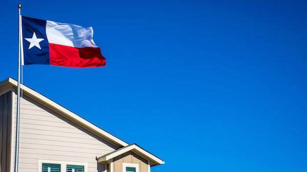 Texas flag flying over house