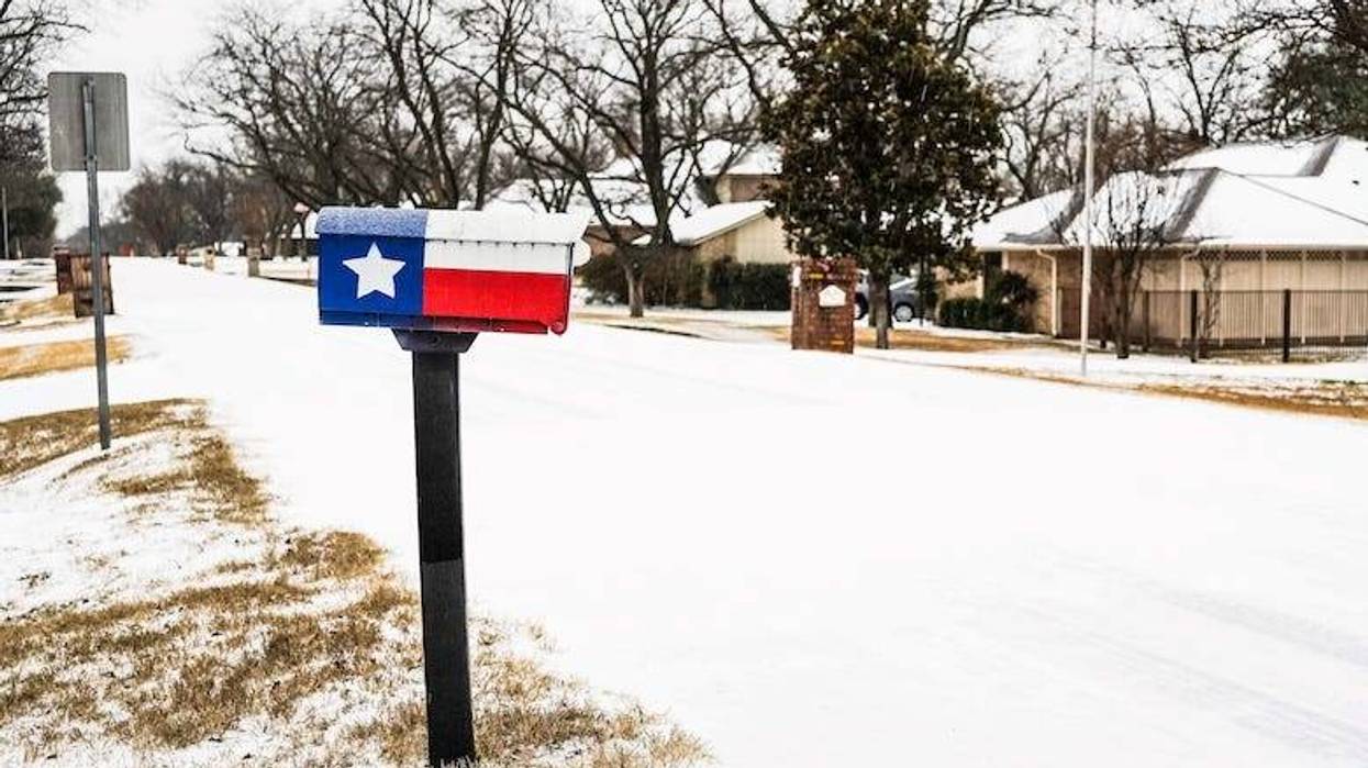Texas flag mailbox in a snowy neighborhood