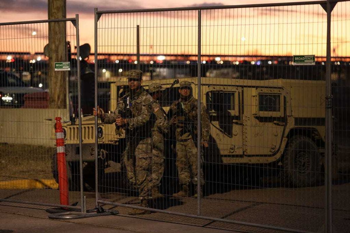 Texas National Guard soldiers wait nearby the boat ramp where law enforcement enter the Rio Grande at Shelby Park