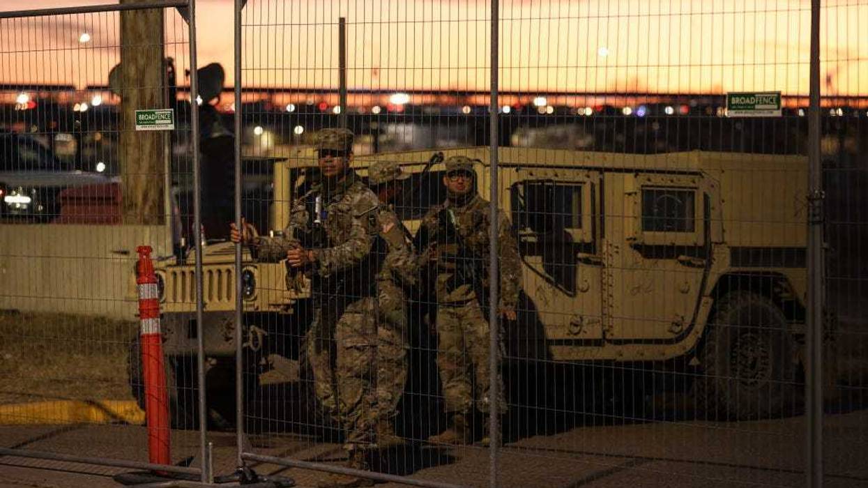 Texas National Guard soldiers wait nearby the boat ramp where law enforcement enter the Rio Grande at Shelby Park